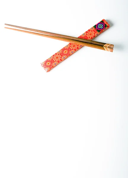 stock image Pair of wooden chopsticks over white