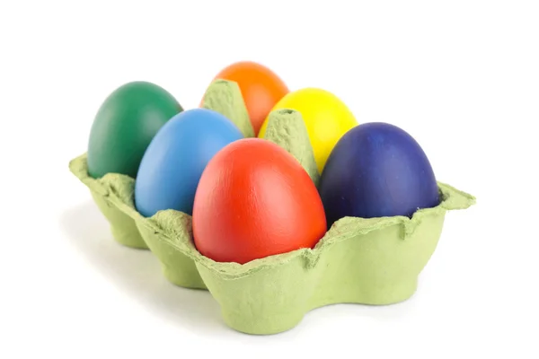 Colored Easter eggs in carton over white — Stock Photo, Image