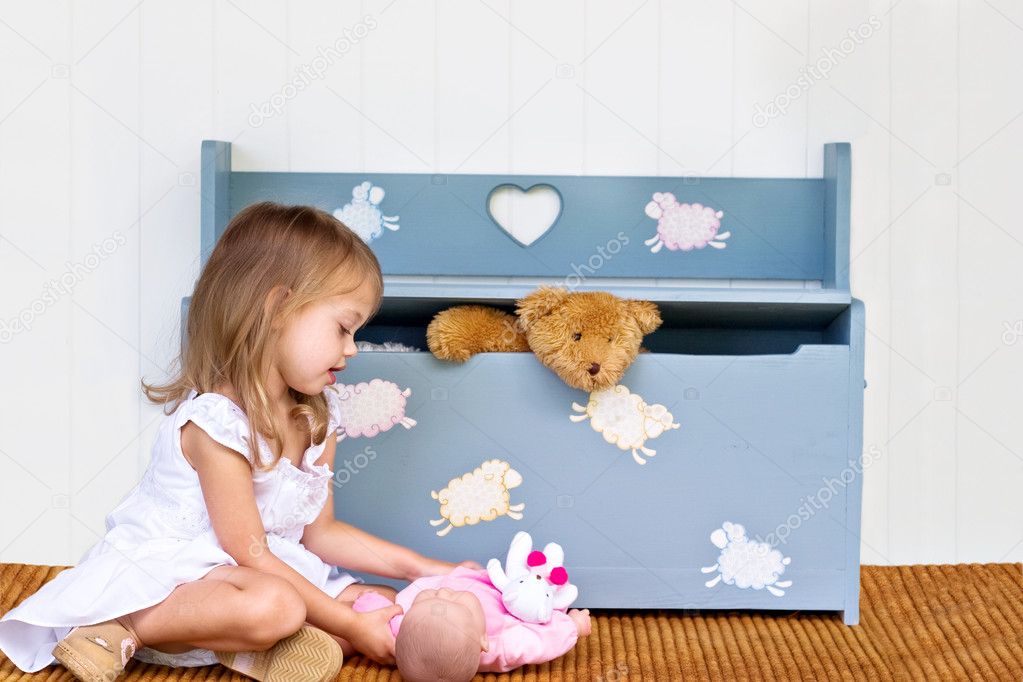 Child Playing by a Toy Box
