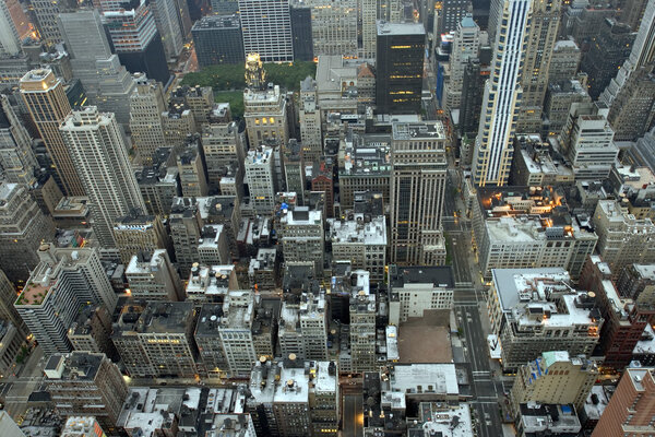 Overhead view of buildings in Midtown Manhattan in New York City in early morning light.