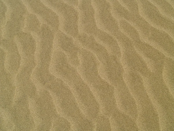 Abstrakt bakgrund av sand krusningar på stranden — Stockfoto
