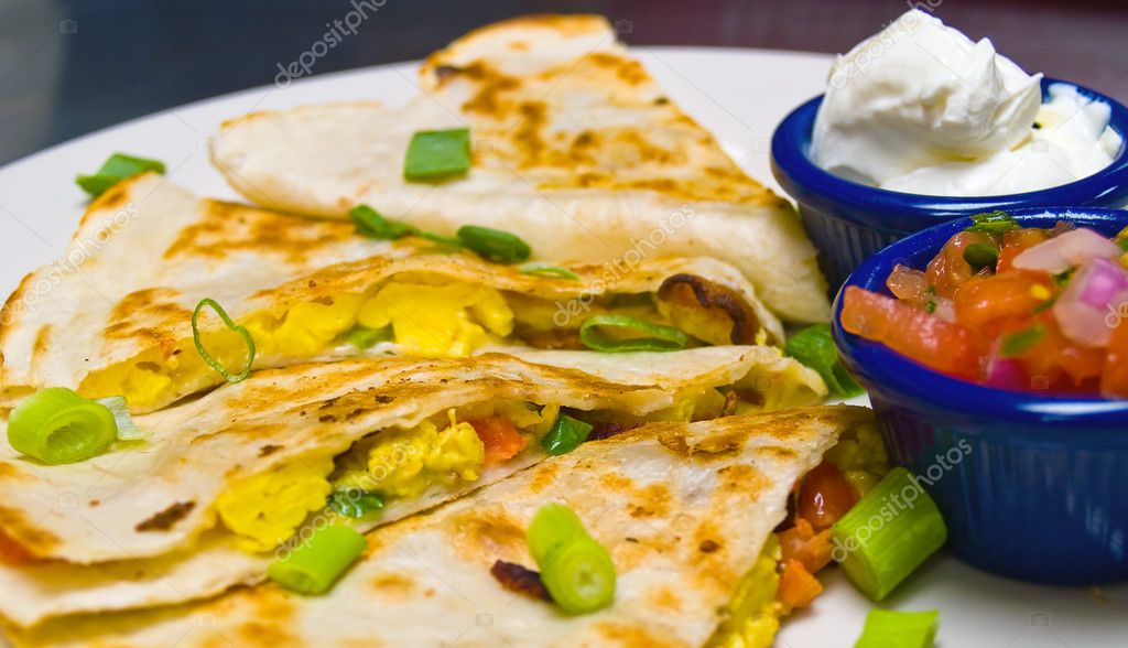 Breakfast Quesadilla with Sour Cream and Salsa Stock Photo by