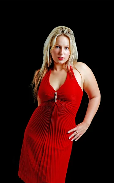 Young woman wearing a red dress on black — Stock Photo, Image