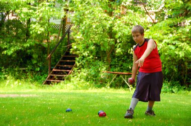 Boy Getting Ready To Throw Bocce Ball clipart