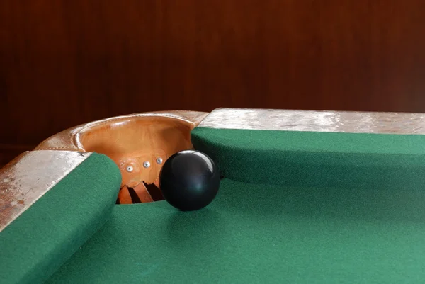 Black snooker ball by corner pocket — Stock Photo, Image