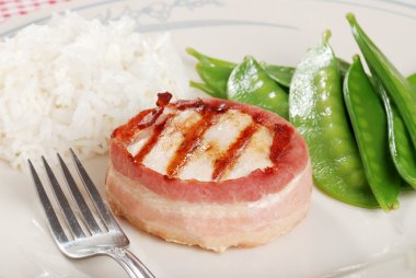 Bacon wrapped chicken with rice and snow clipart