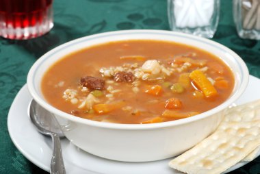 Beef barley soup focus on front bowl rim clipart