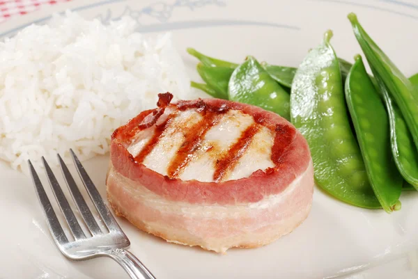 Bacon wrapped chicken with rice and snow — Stock Photo, Image