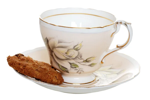 Biscoito com xícara de chá velho e pires — Fotografia de Stock