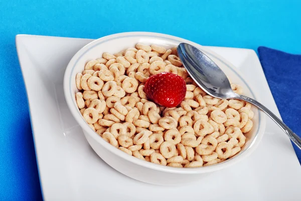Bowl of cereal with strawberry and spoon — Stock Photo, Image