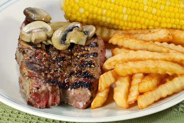 Closeup short ribs with fries and corn — Stock Photo, Image