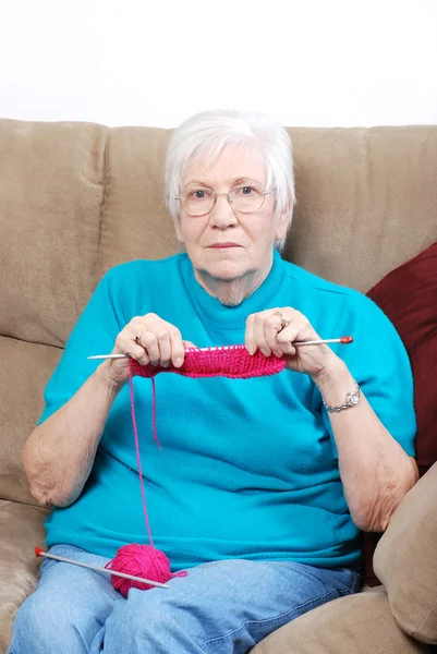 Senior woman counting knitting stitches — Stock Photo, Image