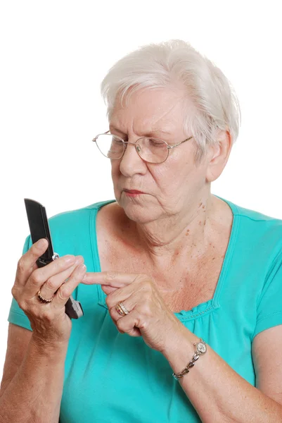 Старшая женщина набирает номер мобильного телефона — стоковое фото