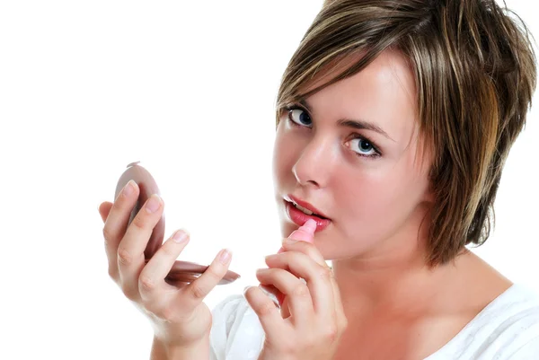 Teenager putting on lipstick — Stock Photo, Image