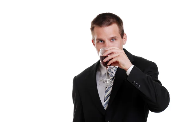 Молодий бізнесмен п'є червоне вино — стокове фото
