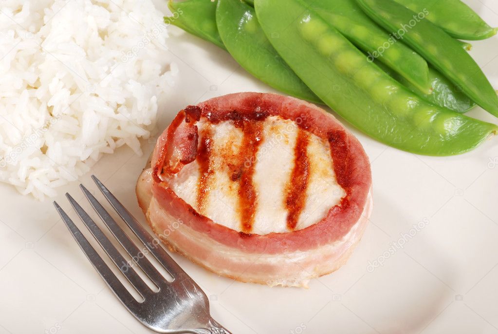 Bacon wrapped chicken with fork