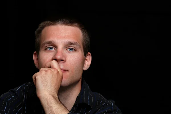 stock image Young Man thinking on black background