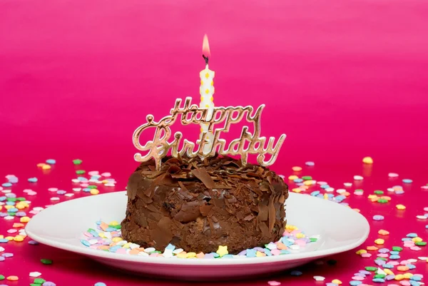 Chocolate birthday cake on pink — Stock Photo, Image