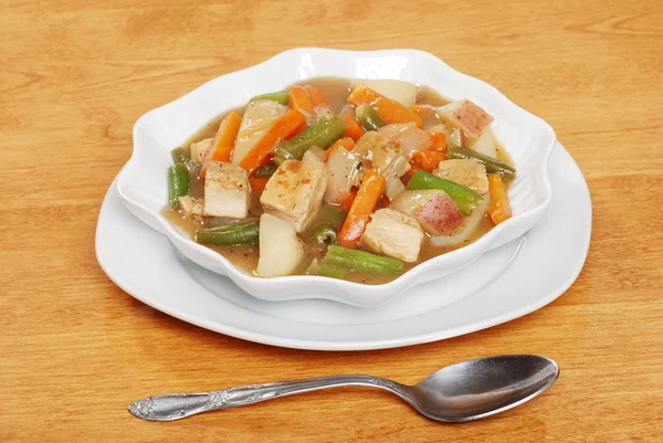 Chicken stew with a spoon — Stock Photo, Image