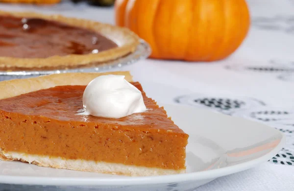 Closeup pumpkin pie slice and whip cream — Stock Photo, Image