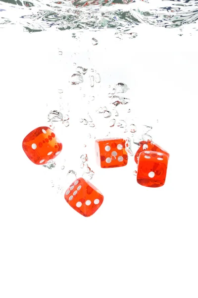 Red transparent dice falling into the cl — Stock Photo, Image