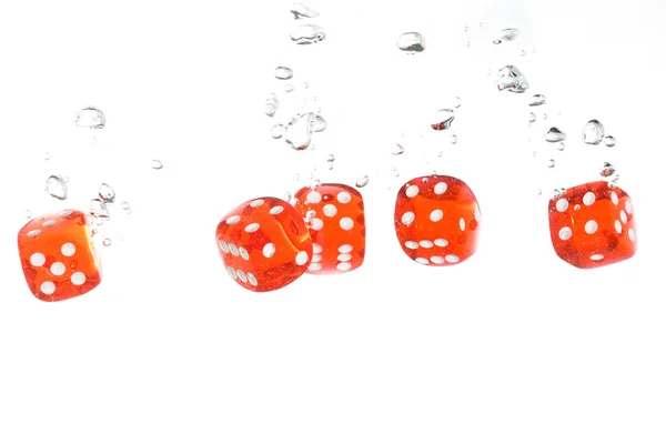 Red transparent dice falling into the cl — Stock Photo, Image
