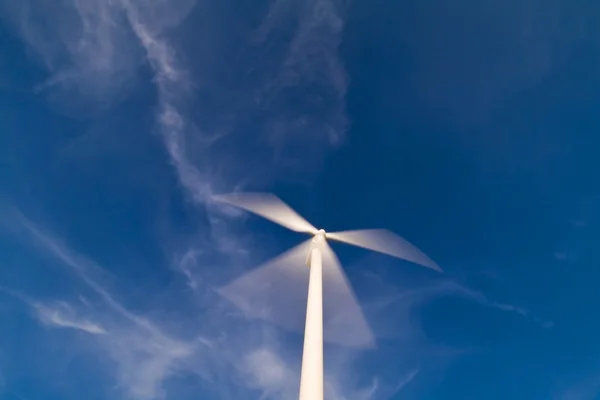 Una sola turbina de viento en un cielo azul —  Fotos de Stock