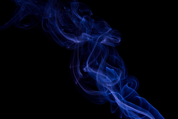 Blue colored smoke on a black background