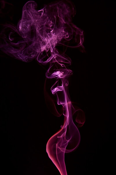 Pink colored smoke on a black background