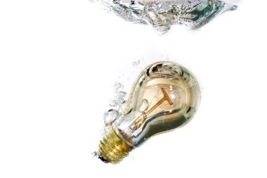 A light bulb falling into clear water clipart