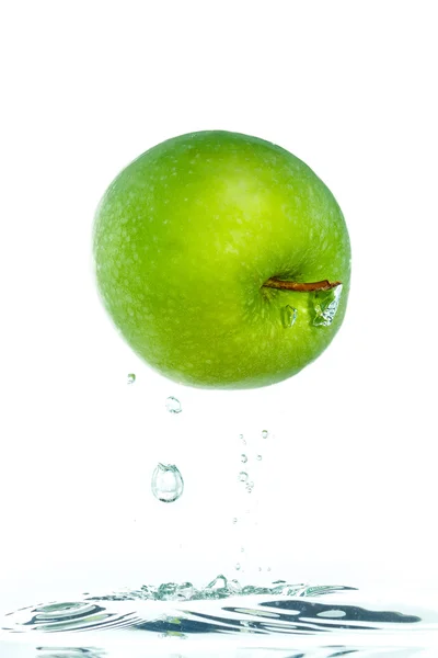 An apple jumping out of the water — Stock Photo, Image