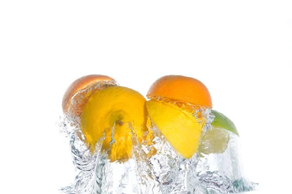 Citrus fruit jumping out of the clear wa — Stock Photo, Image