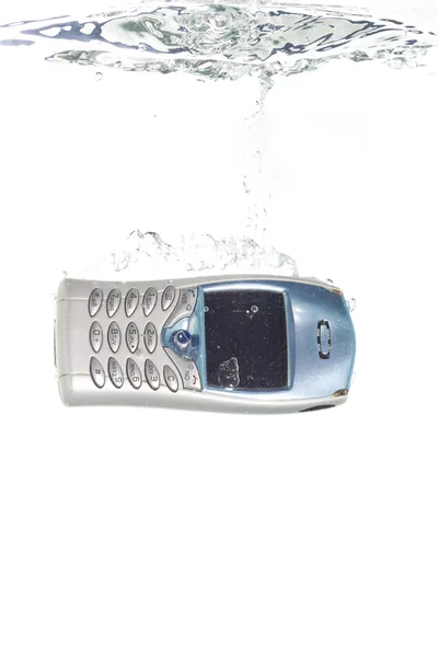 A cellphone falling into clear water — Stock Photo, Image