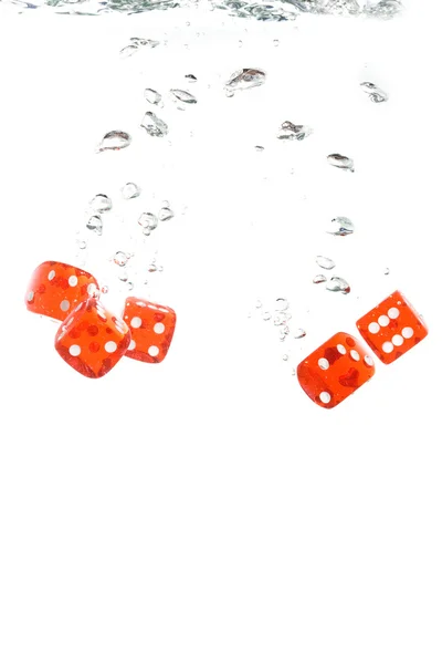 Red dice falling into the water — Stock Photo, Image