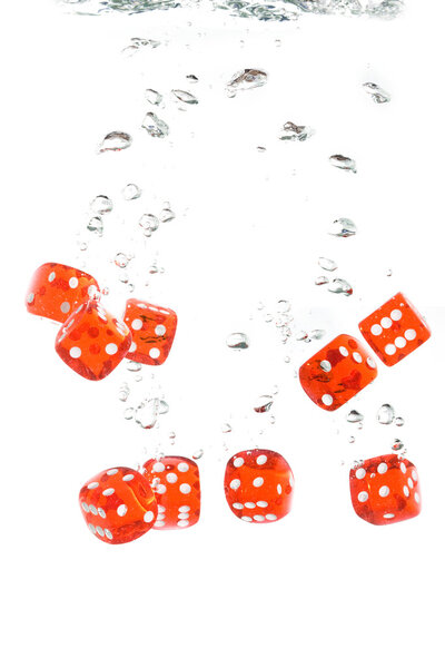 Red transparent dice in water