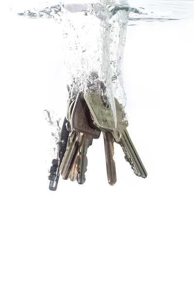 Un porte-clés tombant dans l'eau claire Images De Stock Libres De Droits