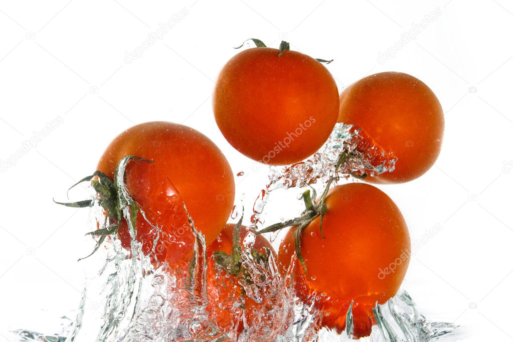 Tomatoes jumping out of the clear water
