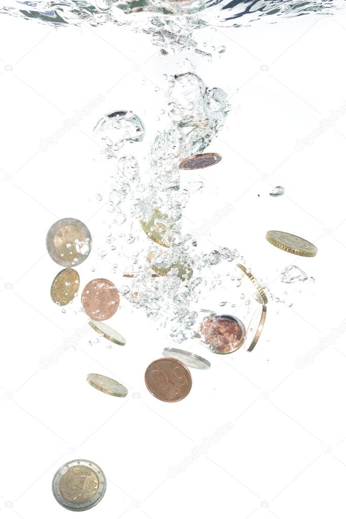 Euro coins falling into the clear water