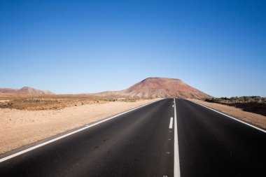 An endless road on the island of Fuertev clipart