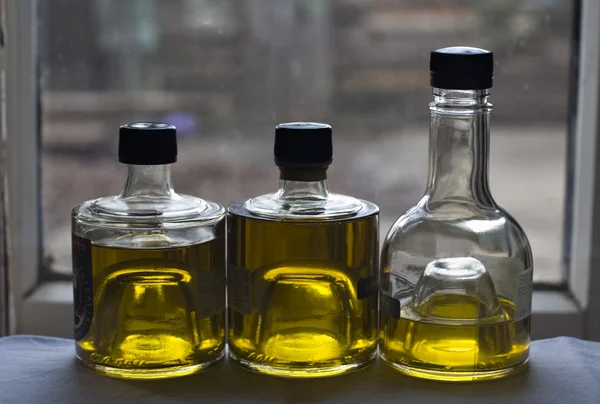 Tres botellas de aceite de oliva Imagen de archivo