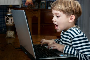 Boy playing computer game clipart