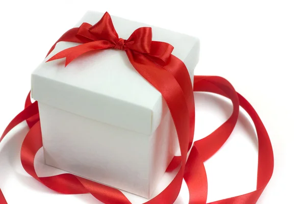 White gift box with red ribbon and bow — Stock Photo, Image