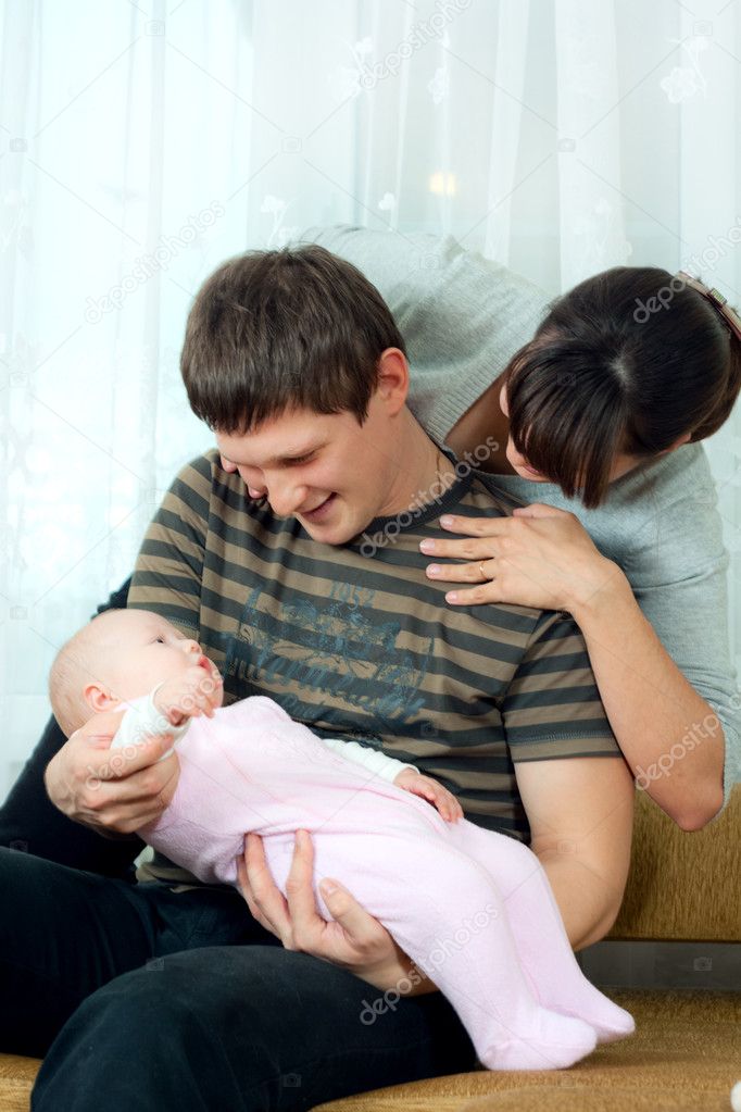 Happy family - mother, father and baby