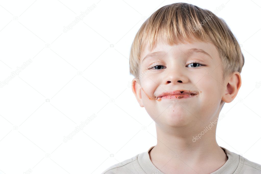 Boy with chocolate on the face isolated