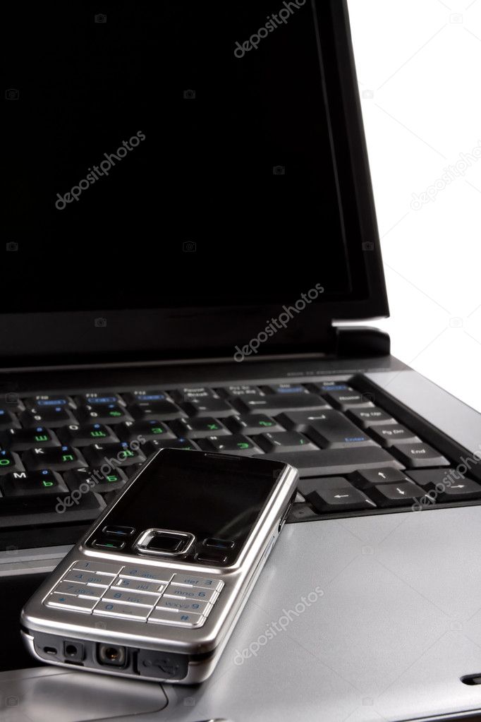 Laptop and cell phone on desktop