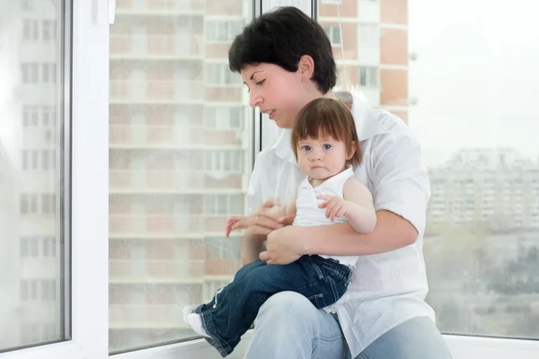 Mother and daughter near window — Stock Photo, Image