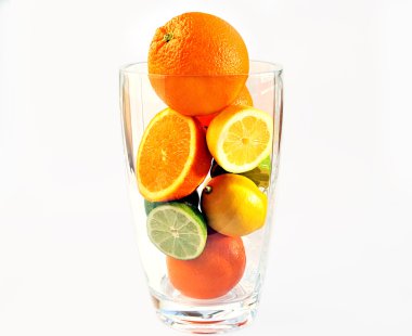 Oranges, lemons and limes in the vase. clipart