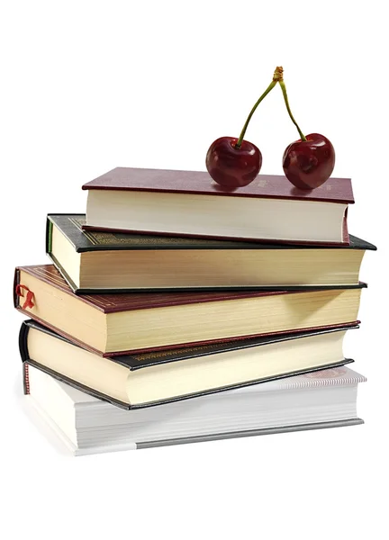Högen av böcker och två sötkörsbär. — Stockfoto