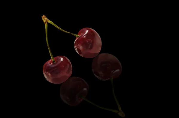 Two sweet cherries isolated over black. — Stock Photo, Image