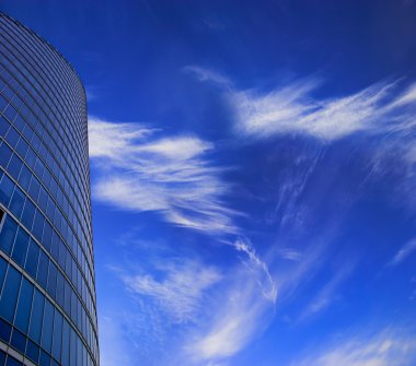 Skyscraper facade on blue sky clipart